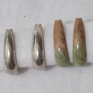 two sets of hoop pierced earrings.